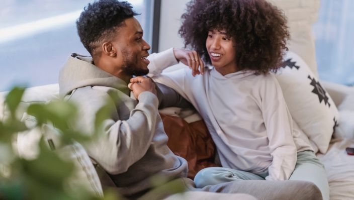 A couple maintaining distance chatting